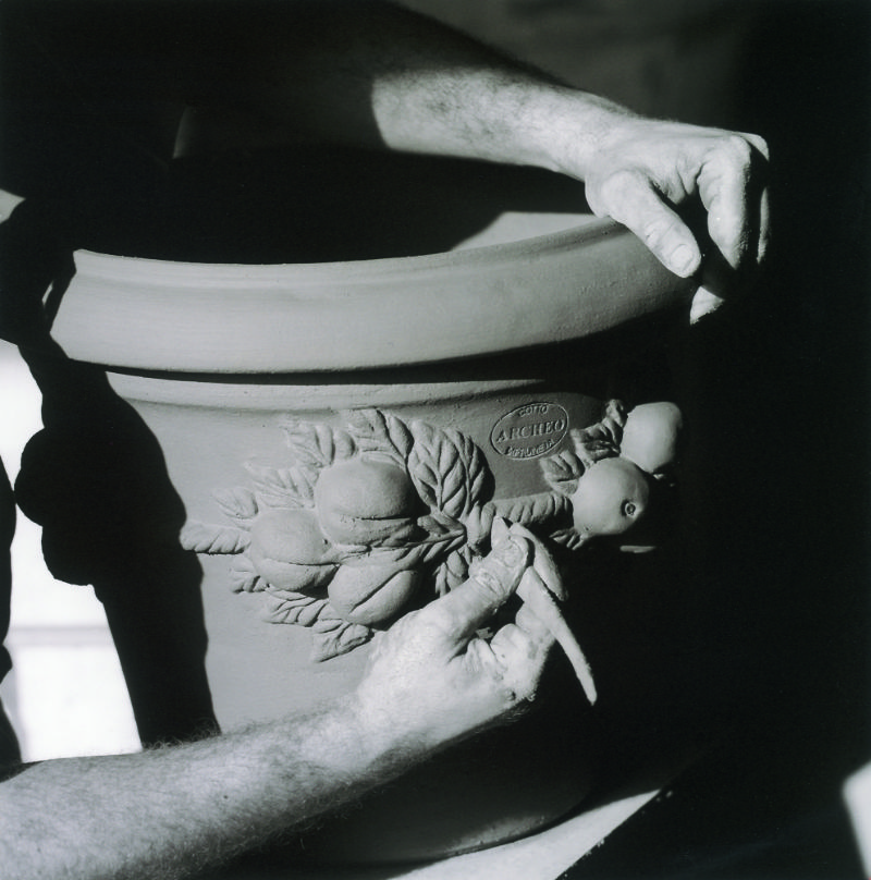 An Italian artisan crafting the rim of a pot