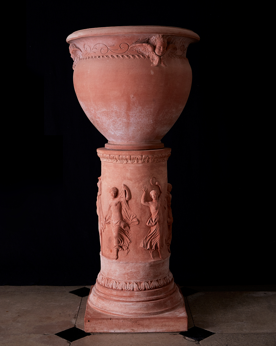 terracotta rounded crater-pot with three angels on terracotta base